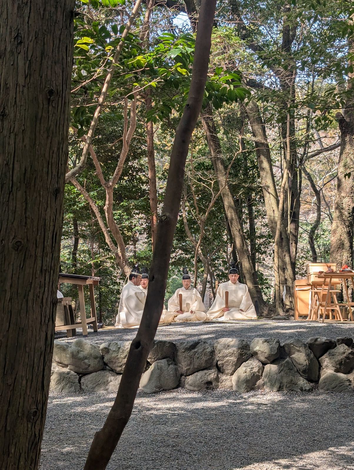 Shinto priests conducting a ceremony in the forest