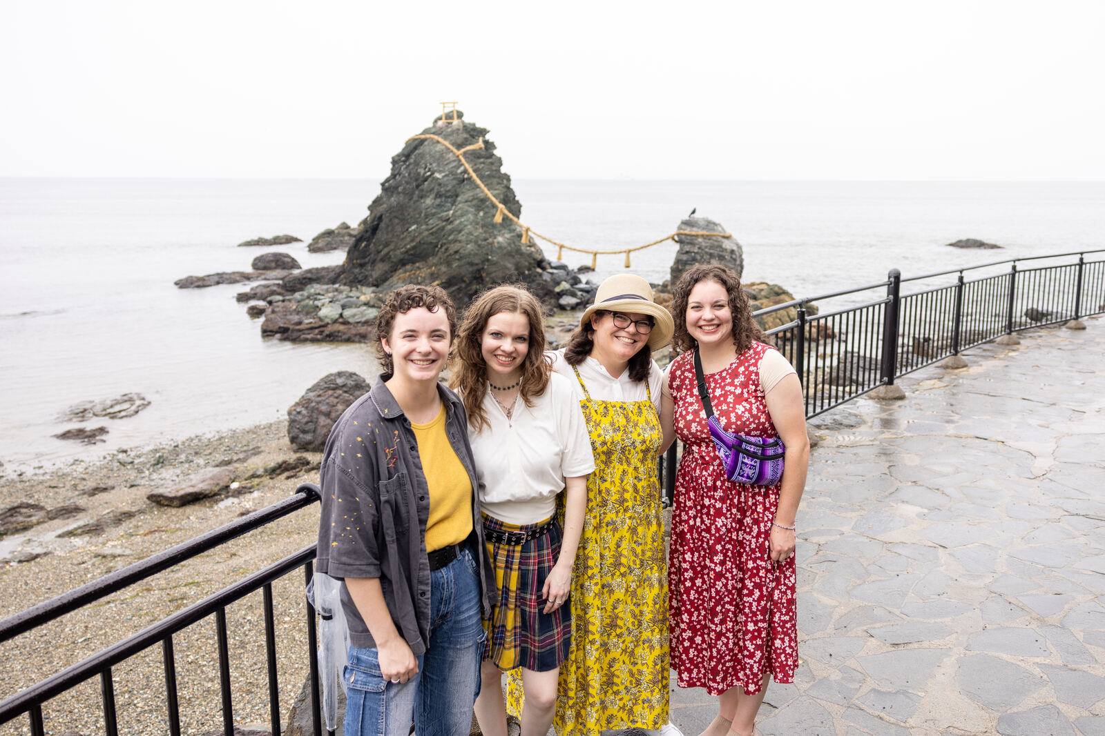Guests posing together in front of the Wedded Rocks