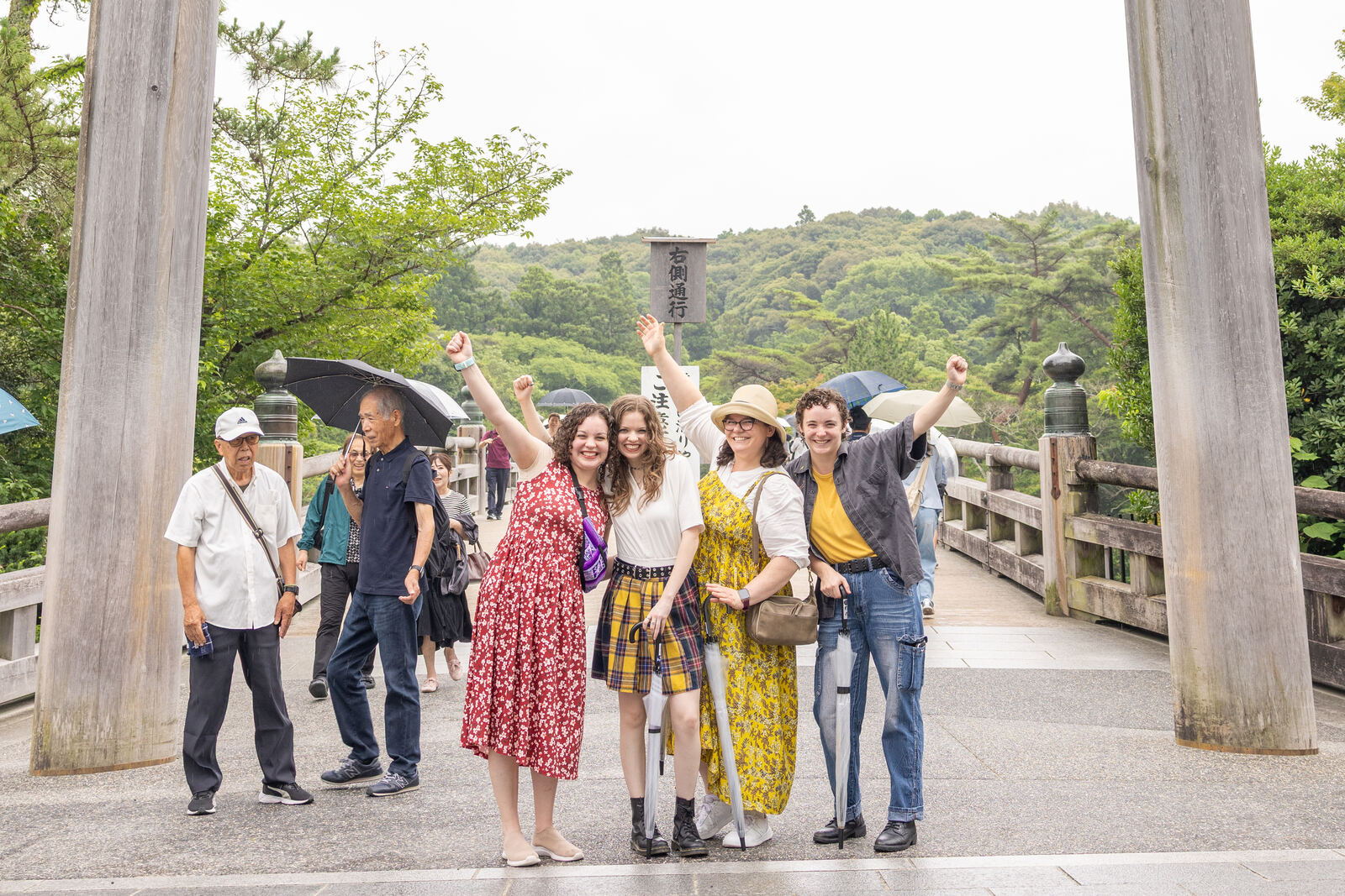 Guests cheering with arms raised on the bridge