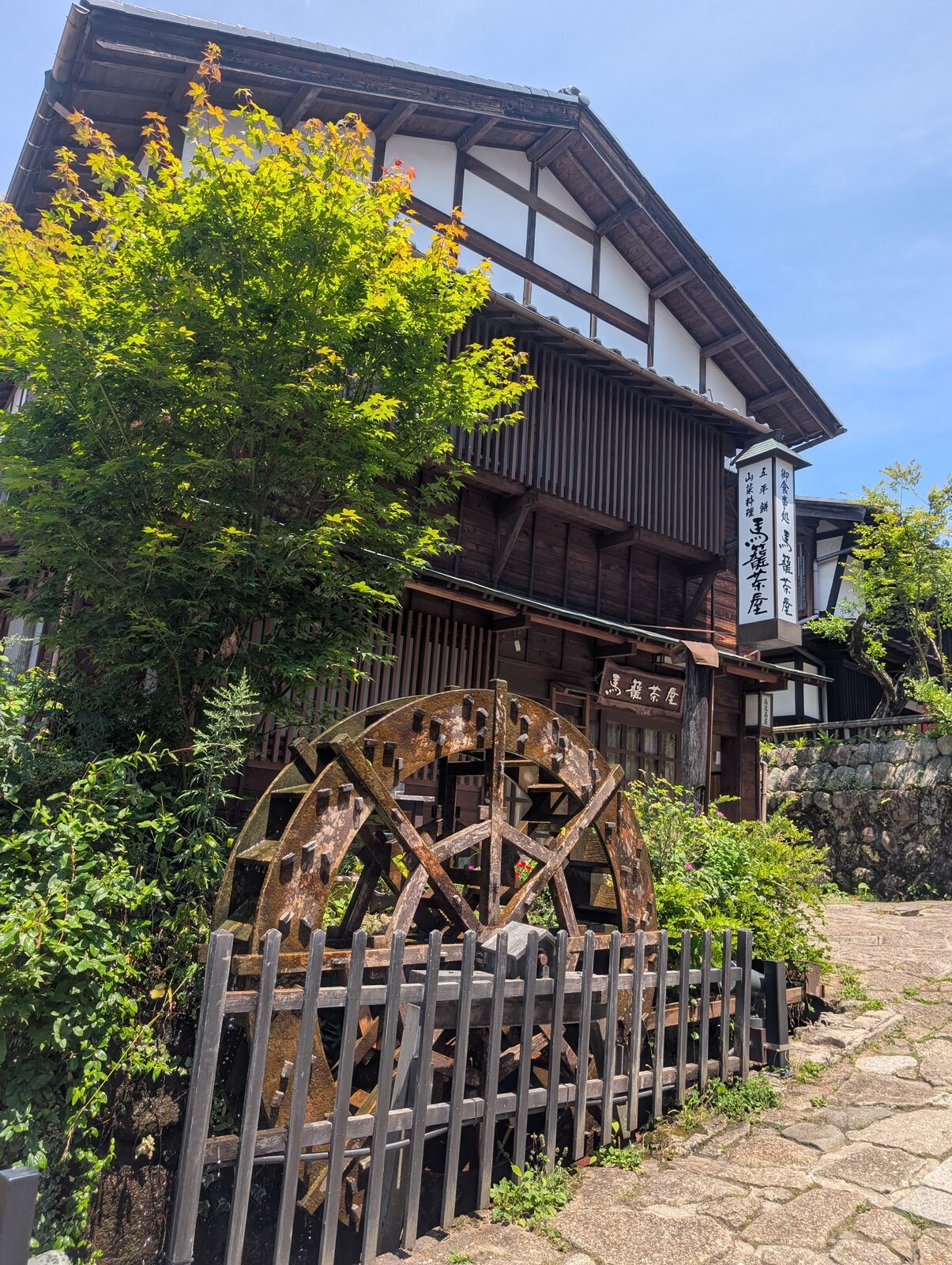 A traditional teahouse with a water wheel in Magome