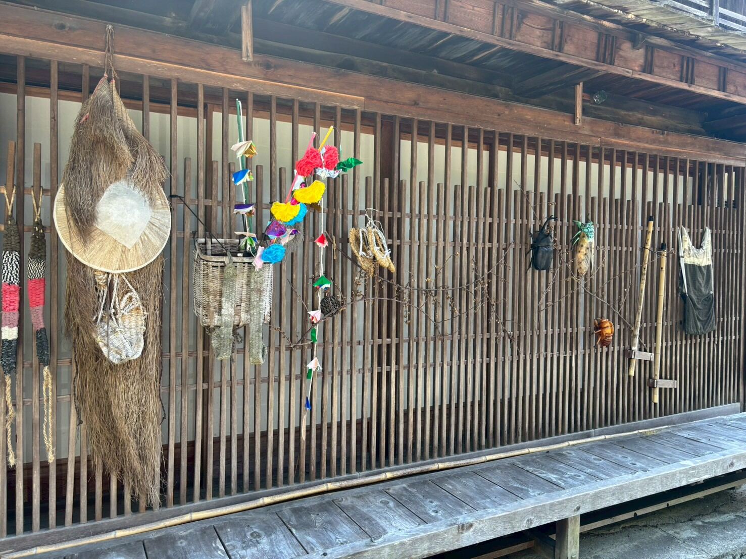 Traditional straw hats and woven baskets displayed outside a Tsumago shop